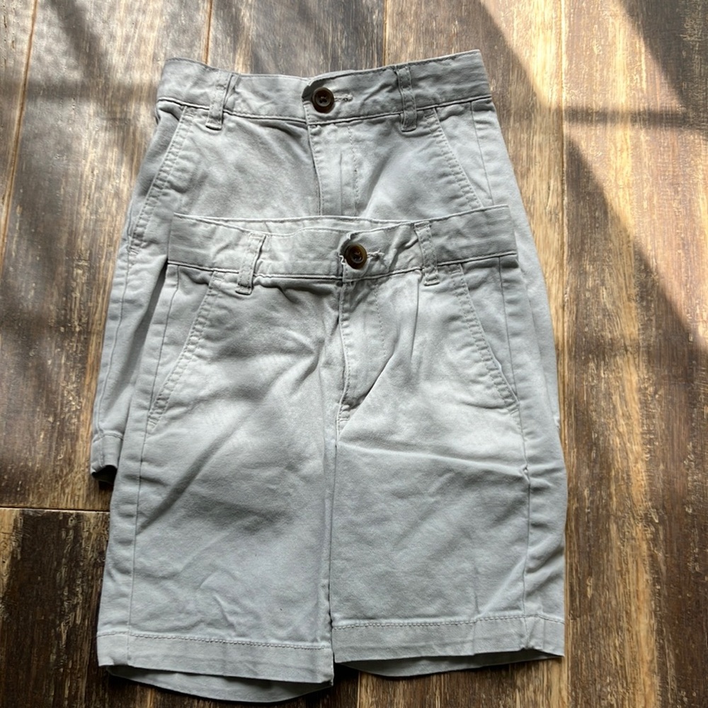 Two pairs of light tan shorts